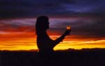 A woman holding an object in her hand.