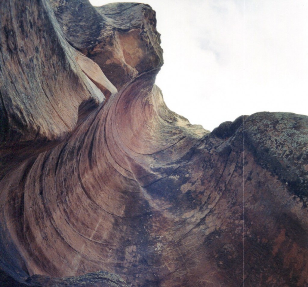 A rock formation with many layers of color and shapes.