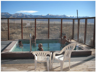 A group of people in an outdoor pool.