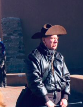 man wearing a leather jacket and a brown sombero hat