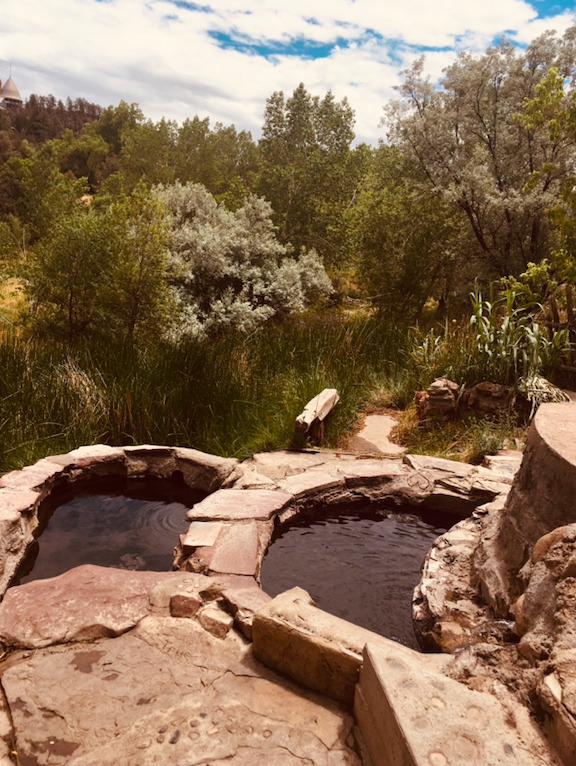 A couple of hot tubs in the middle of some rocks