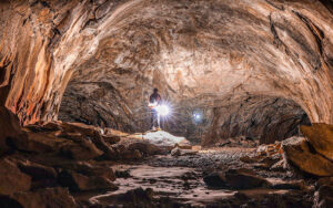 A person standing in the middle of an underground cave.