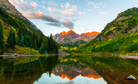 A lake with mountains in the background and trees