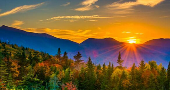 view of sunrise coming up over the mountains.